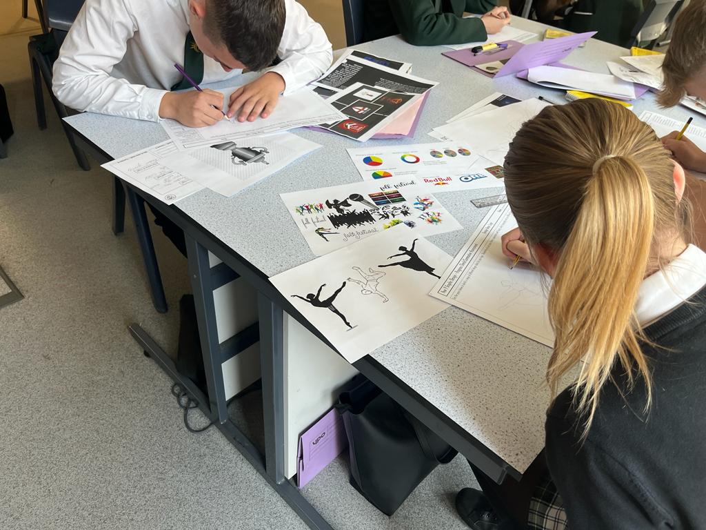 Y9 Graphics student making designs for a festival of their choice